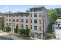 Exterior of a modern building with large windows, showcasing a blend of gray panels and brick accents in an urban setting at 660 Glen Iris Dr # 206 & 109, Atlanta, GA 30308