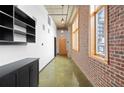 Bright hallway featuring exposed brick and industrial-style lighting at 660 Glen Iris Dr # 206 & 109, Atlanta, GA 30308