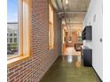 Long hallway showcasing exposed brick and polished concrete floors at 660 Glen Iris Dr # 206 & 109, Atlanta, GA 30308