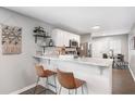 Eat-in kitchen featuring a breakfast bar, modern white cabinets, granite countertops, and stainless steel appliances at 999 Washington Sw St, Atlanta, GA 30315