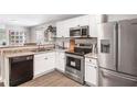 Bright kitchen featuring stainless steel appliances, white cabinets, and stone countertops at 999 Washington Sw St, Atlanta, GA 30315