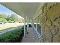 Charming covered porch with stone accents, offering a relaxing outdoor space at 1001 Wiley Bridge Rd, Woodstock, GA 30188