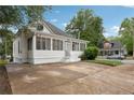 Classic home with a screened porch and a well-maintained lawn, offering a welcoming curb appeal at 1796 Center Ave, East Point, GA 30344