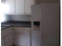 A basic kitchen with white cabinets and a white refrigerator at 2835 Burton Rd, Atlanta, GA 30311