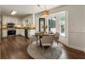 Bright kitchen boasts stainless steel appliances, granite countertops, and an adjacent dining area with a bay window at 5600 Surrey Ct, Alpharetta, GA 30009