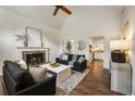 Bright living room with hardwood floors, vaulted ceilings, a cozy fireplace, and modern decor at 5600 Surrey Ct, Alpharetta, GA 30009