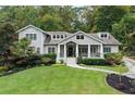 Charming two-story home with a well-manicured lawn, beautiful landscaping, and a welcoming front porch at 2908 Mabry Ne Ln, Brookhaven, GA 30319
