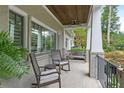 Inviting covered porch with rocking chairs, a bench, and a view of the landscaped yard at 2908 Mabry Ne Ln, Brookhaven, GA 30319