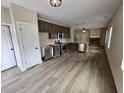Modern kitchen with stainless steel appliances, wooden cabinets, and an open design connecting to the living area at 42 Woodhaven Path, Rockmart, GA 30153