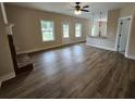 Bright living room showcasing hardwood floors, a fireplace, and a seamless transition into the kitchen area at 42 Woodhaven Path, Rockmart, GA 30153