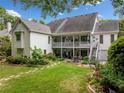 Expansive backyard with a multi-tiered deck, a stone patio, and beautifully landscaped garden beds at 450 Bay Grove Se Rd, Loganville, GA 30052