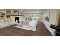 Bright living room with white decor, built-in shelving, fireplace, and hardwood floors at 50 Stonington Pl, Marietta, GA 30068