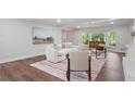 Stylish living room with wood flooring, contemporary decor, and large windows, offering abundant natural light at 50 Stonington Pl, Marietta, GA 30068