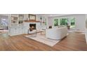 Bright living room features hardwood floors, built-in shelving, and a cozy fireplace, creating an inviting space at 50 Stonington Pl, Marietta, GA 30068