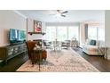 Cozy living room with fireplace, large windows, and comfortable seating, creating a warm atmosphere at 719 Elizabeth Trl, Woodstock, GA 30189