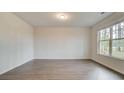 Bright bedroom with large window, wood-look floors, and ample natural light at 145 Bre Dr, Fayetteville, GA 30215
