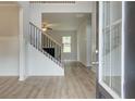 Inviting entryway featuring beautiful floors, staircase, and plenty of natural light showcasing the home's elegant design at 72 Homesite Cooper W Cv, Fayetteville, GA 30215