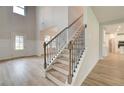 Grand foyer with staircase and views to a bright kitchen with stainless appliances and beautiful wood floors at 72 Homesite Cooper W Cv, Fayetteville, GA 30215