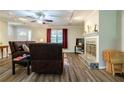 Cozy living room featuring a fireplace, hardwood floors, and lots of natural light at 1420 Hillside Se Pl, Conyers, GA 30094