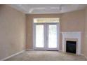 Bright living room with a fireplace and double doors leading to the outside at 3500 Sweetwater Rd # 522, Duluth, GA 30096