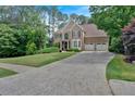 Beautiful traditional home with lush landscaping, a spacious driveway, and a two-car attached garage at 4012 Ironhill Ln, Woodstock, GA 30189
