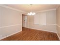 Dining room features wood-look floors, decorative molding, and contemporary chandelier at 592 Cricket Hill Trl, Lawrenceville, GA 30044