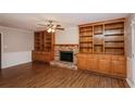 Cozy living room featuring a brick fireplace and custom-built wooden bookshelves at 592 Cricket Hill Trl, Lawrenceville, GA 30044