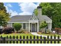 Charming home with brick facade, manicured lawn, and a quaint picket fence at 129 2Nd Se Ave, Atlanta, GA 30317