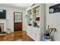 Bright living room features a fireplace, hardwood floors, and custom built-in shelving at 129 2Nd Se Ave, Atlanta, GA 30317