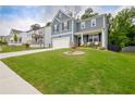 Beautiful home with a lush green lawn, complemented by mature trees in a desirable neighborhood at 7730 Demeter Dr, Fairburn, GA 30213