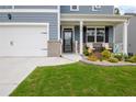 Inviting front porch featuring a seating area and well-manicured landscaping, enhancing curb appeal at 7730 Demeter Dr, Fairburn, GA 30213