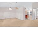Living room featuring neutral colors and a pass-through to the kitchen at 991 Lisa Kay Dr, Lawrenceville, GA 30046