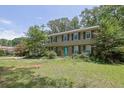 Charming two-story home with a well-manicured lawn and a large tree at 1315 Arden Sw Dr, Marietta, GA 30008