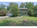 Traditional two-story home with a large front lawn and mature trees at 1315 Arden Sw Dr, Marietta, GA 30008