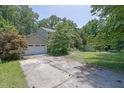 Traditional two-story home with a large front lawn and mature trees at 1315 Arden Sw Dr, Marietta, GA 30008