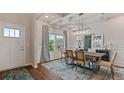 Elegant dining room with coffered ceiling, wainscoting, and modern light fixture at 2447 Cadenza Cir, Dacula, GA 30019