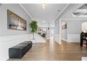 Open foyer with wood floors, a staircase, and ample natural light at 7095 Evening Dew Dr, Cumming, GA 30028
