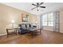 Comfortable living room featuring hardwood floors, a ceiling fan, and ample natural light at 1065 Dalby Way, Austell, GA 30106