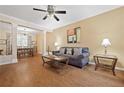 Open-concept living area with wood floors, ceiling fan, and stylish furnishings at 1065 Dalby Way, Austell, GA 30106