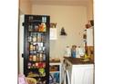 Practical laundry room with shelving and storage solutions, enhancing functionality and organization at 1231 St James Pl, Loganville, GA 30052