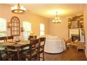 Bright living room featuring a decorative fireplace, an abundance of windows, and sleek hardwood floors at 1231 St James Pl, Loganville, GA 30052
