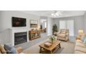 Bright living room with fireplace, neutral walls, and sliding doors at 132 Tara Commons Dr, Loganville, GA 30052
