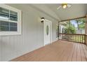 Inviting screened-in front porch with a white front door and wood flooring providing a relaxing outdoor space at 1447 High Sierra Dr, Lawrenceville, GA 30043