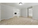 Open-concept living room with tile flooring and a glimpse of the living room with a fireplace at 1447 High Sierra Dr, Lawrenceville, GA 30043