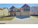 Beautiful two-story home with a spacious driveway, brick exterior, and well-maintained lawn at 2436 Cadenza Cir, Dacula, GA 30019