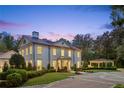 Elegant two-story home featuring manicured lawn, circular driveway, and porte-cochere at 3625 Tuxedo Nw Rd, Atlanta, GA 30305