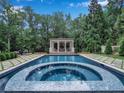 Relaxing pool with spa and a poolside gazebo in a lush, private backyard setting at 3625 Tuxedo Nw Rd, Atlanta, GA 30305