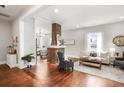 Bright living room with hardwood floors, white shiplap walls, a brick fireplace, and stylish furnishings for comfortable living at 11 Pine St, Covington, GA 30014