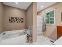 Bathroom featuring a soaking tub with a separate shower at 410 Lima Ct, Woodstock, GA 30188