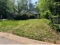 Inviting single-story home with a well-maintained front yard and mature landscaping at 410 Lima Ct, Woodstock, GA 30188